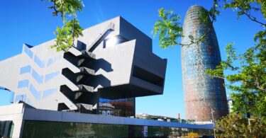 Disseny Hub Barcelona museum (design museum of Barcelona) and Agbar tower in a sunny day